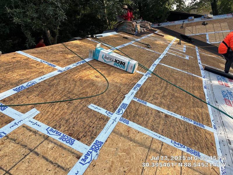 New roof decking with every seam covered in tape, a roll of tape in front
