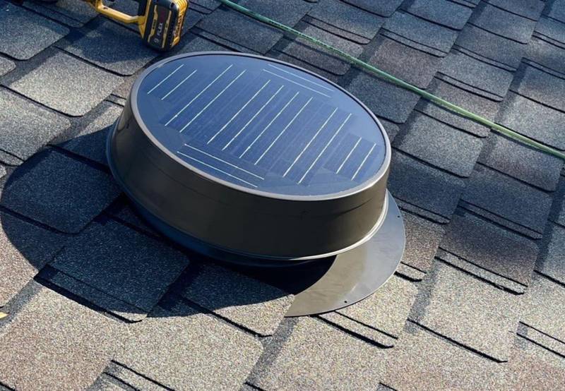 Round low-profile solar attic vent on new shingles